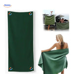 Green microfiber beach towel with magnetic corners for secure placement.