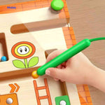 Magnetic pen control game with colorful beads on wooden maze.