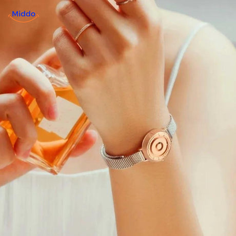 Woman wearing rose gold and white magnetic watch on wrist.