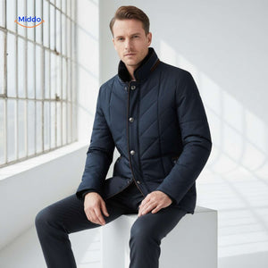 Man wearing quilted jacket seated indoors by window, showcasing fit and warmth.