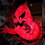 Spooky red-lit monster inflatable peeking through window with atmospheric lighting.