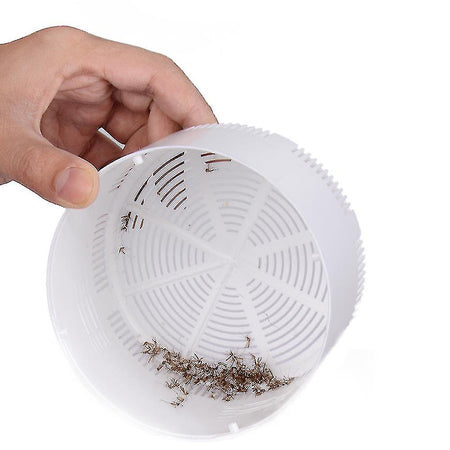 Compact electric mosquito trap shown in hand to demonstrate portable, chemical-free insect control.
