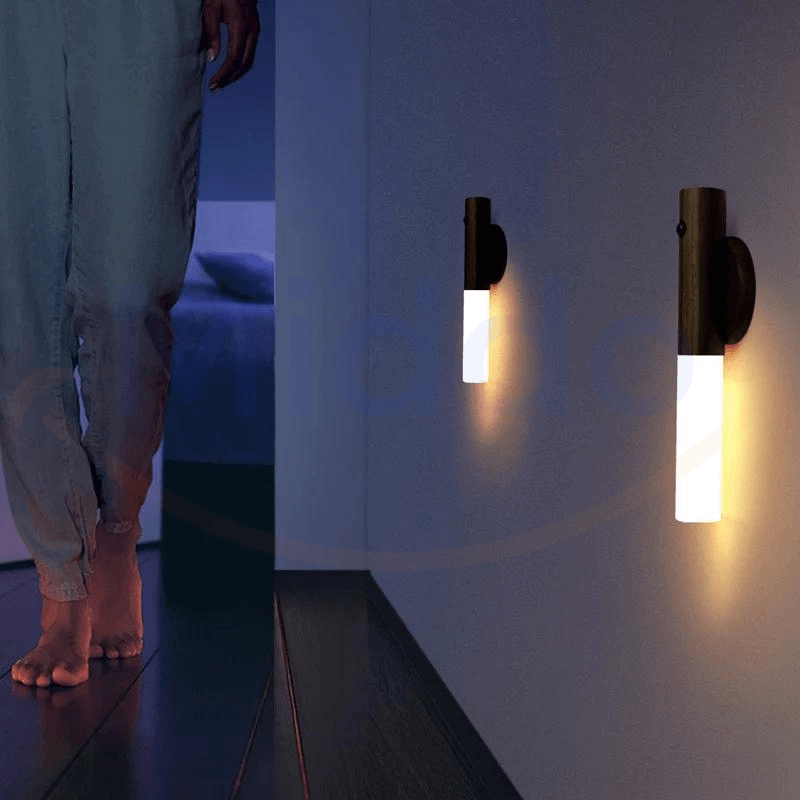 Motion-activated LED lamp illuminating a dark hallway with bright white light.