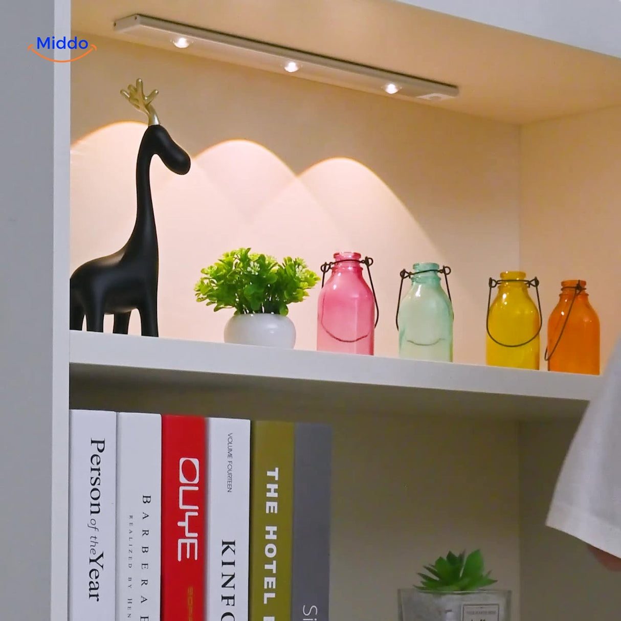 Wireless motion sensor lamp mounted on bookshelf providing automatic ambient lighting.