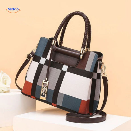 Handbag with multi-color combination and fur pom-pom ornament.