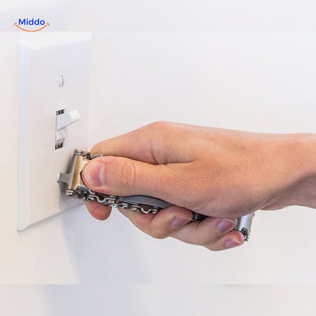 Multi-tool bracelet being used by hand to adjust light switch demonstrating practicality.