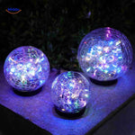 Multicolor LED globe lamp creating vibrant outdoor ambient lighting.