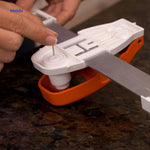Nail positioner with integrated level ensures perfectly straight picture frame installation.