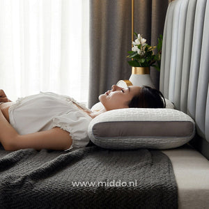 Woman resting peacefully on her side using the ergonomic neck support pillow