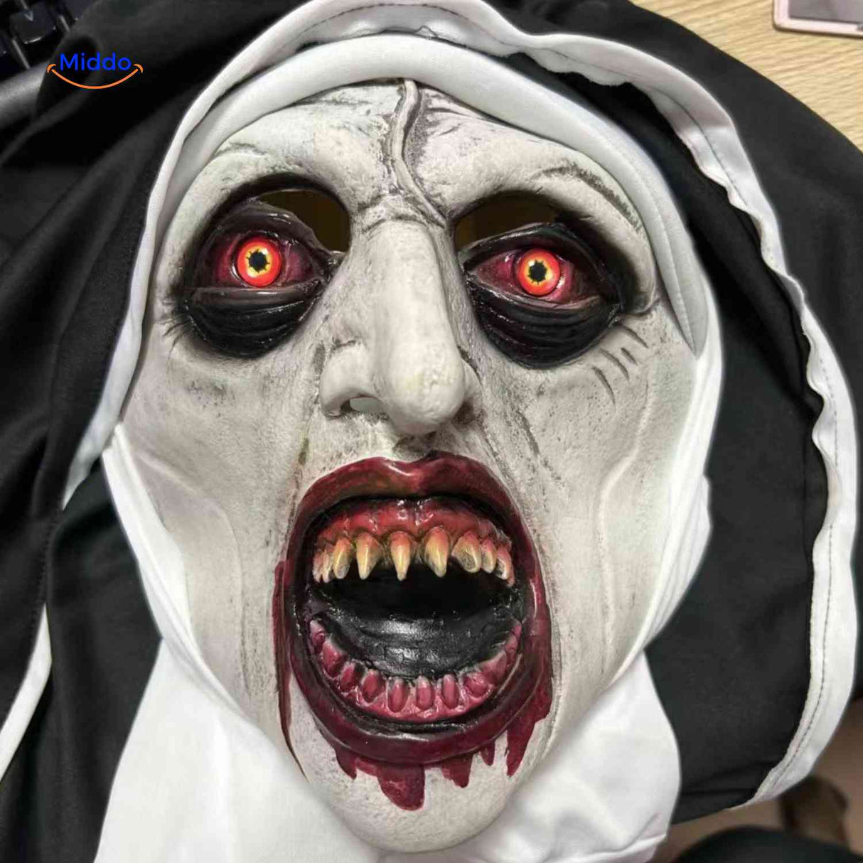 Close-up of nun mask showing creepy eyes with blood effects.