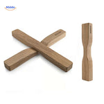 Oak wooden trivet with modern cross-shaped design and natural wood grain.