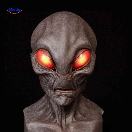Aged latex mask with red eyes and alien-inspired character design.