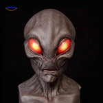 Aged latex mask with red eyes and alien-inspired character design.