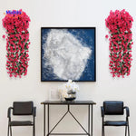 Artificial orchid flowers arranged in a stylish home display.
