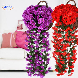 Artificial orchid flowers in rich purple and red tones.
