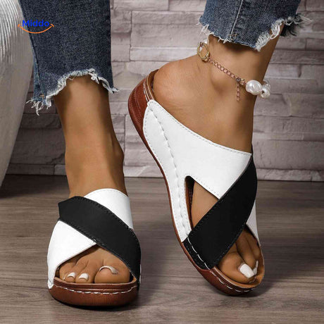 Orthopedic women's sandals with cross strap design for secure arch support.