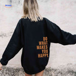 Black oversized hoodie with orange text detail.