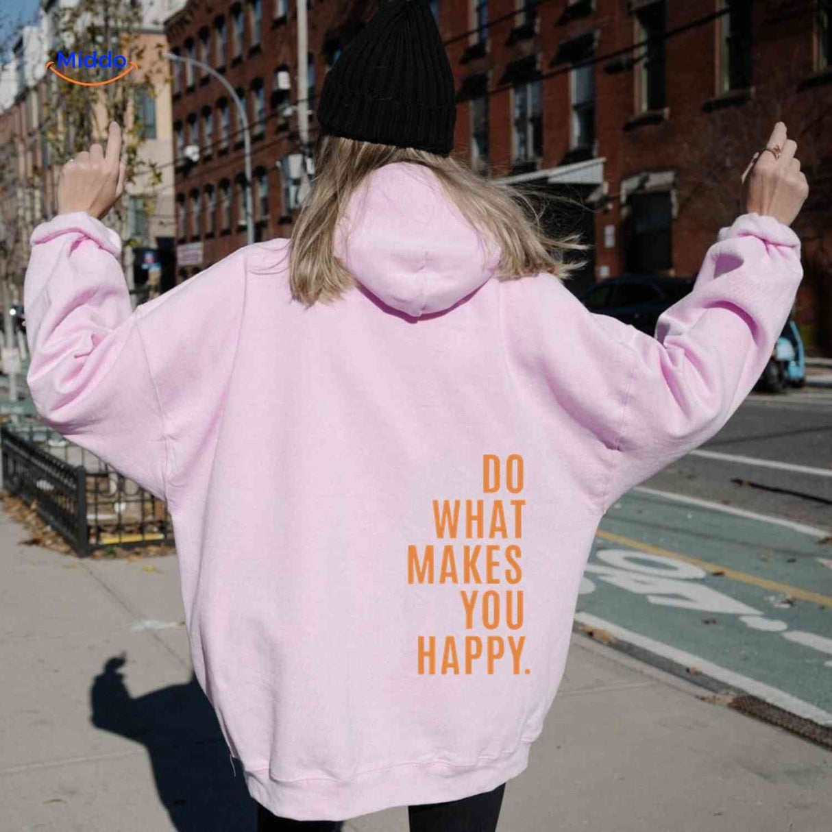 Pink oversized hoodie with orange graphic print.