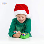 Hands using electric light-up pen to paint and decorate wooden ornaments with precision.