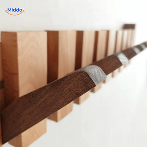 Detailed view of handmade wooden piano coat rack's construction and hooks.