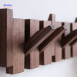 Modern piano coat rack design in handmade wood with minimalist architectural appeal.