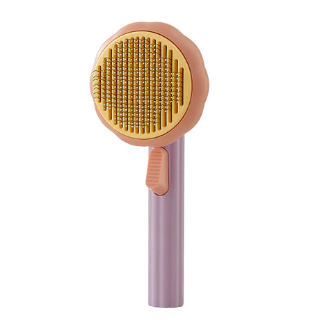 Pink KatKam deshedding brush for reducing cat shedding and maintaining coat health.