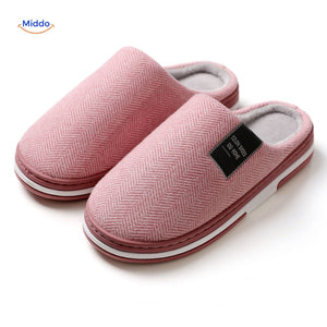Close-up fabric detail of pink non-slip cotton slippers.