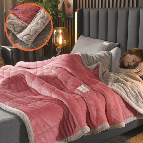 Dark rose and grey two-tone fleece blanket layered on bed.