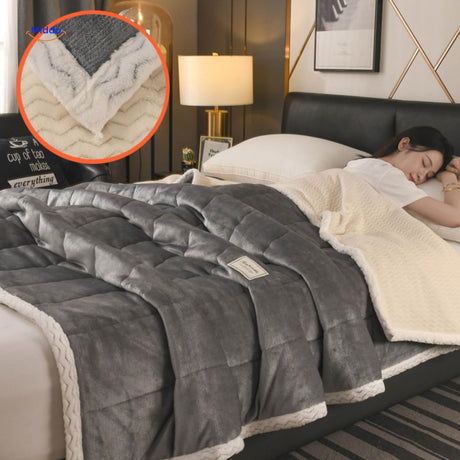 Grey and white combination wool blanket folded on bed.