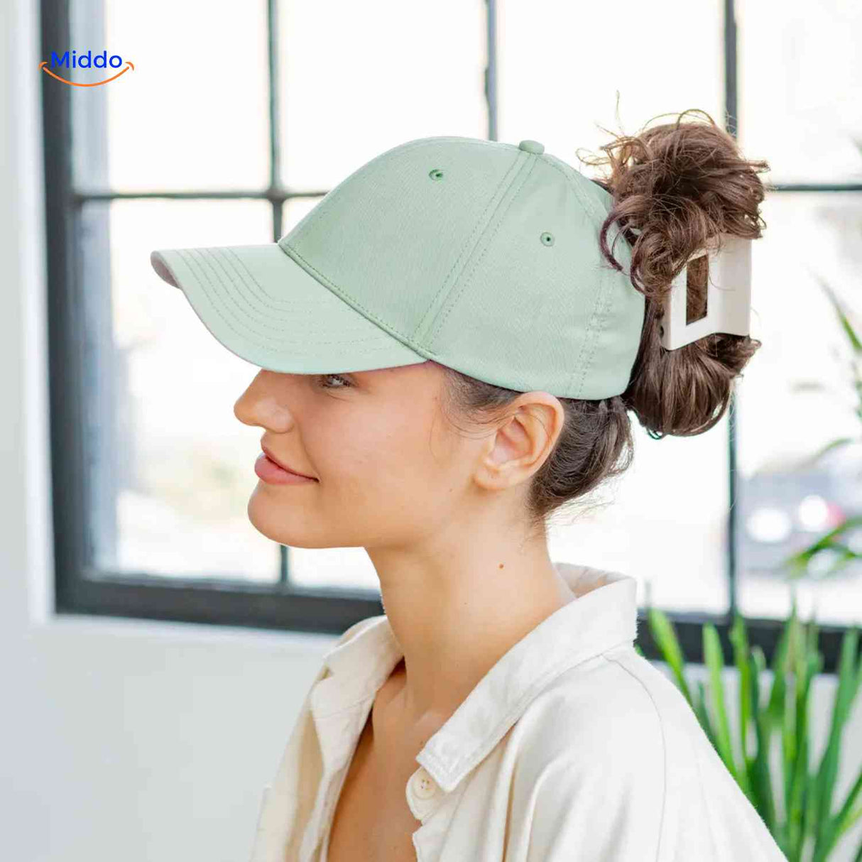 Light green ponytail cap with magnetic clip and hair opening for trendy bun.