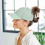 Light green ponytail cap with magnetic clip and hair opening for trendy bun.
