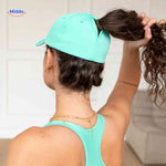 Back view of mint green ponytail cap showing magnetic hair opening design.