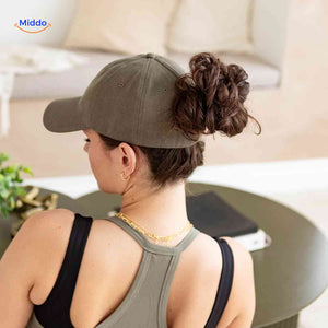 Olive green ponytail cap with hair opening, perfect for relaxed home style.