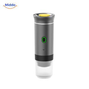 Portable espresso machine ready to brew with coffee capsule inserted.