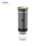 Portable espresso machine ready to brew with coffee capsule inserted.