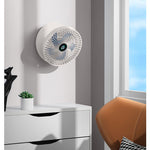 Wall-mounted portable cooling fan providing space-saving air circulation.