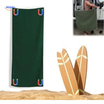 Compact sand-free towel with magnetic attachment for travel and outdoor use.