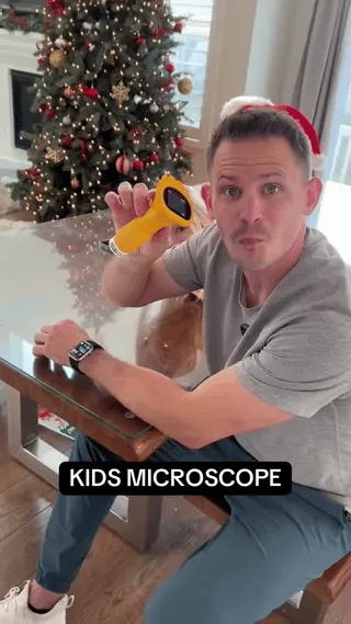White portable digital microscope for children with compact form factor.