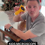 White portable digital microscope for children with compact form factor.