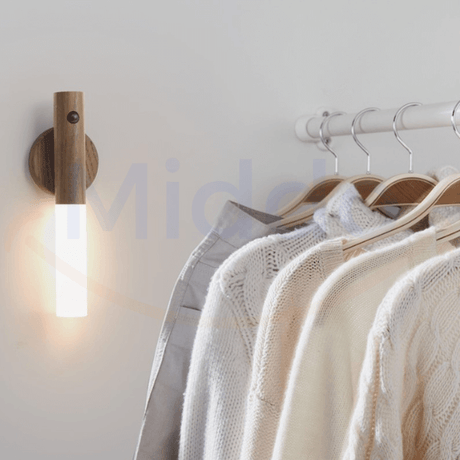 Compact motion-activated LED lamp sitting on shelf or cabinet for hands-free lighting.