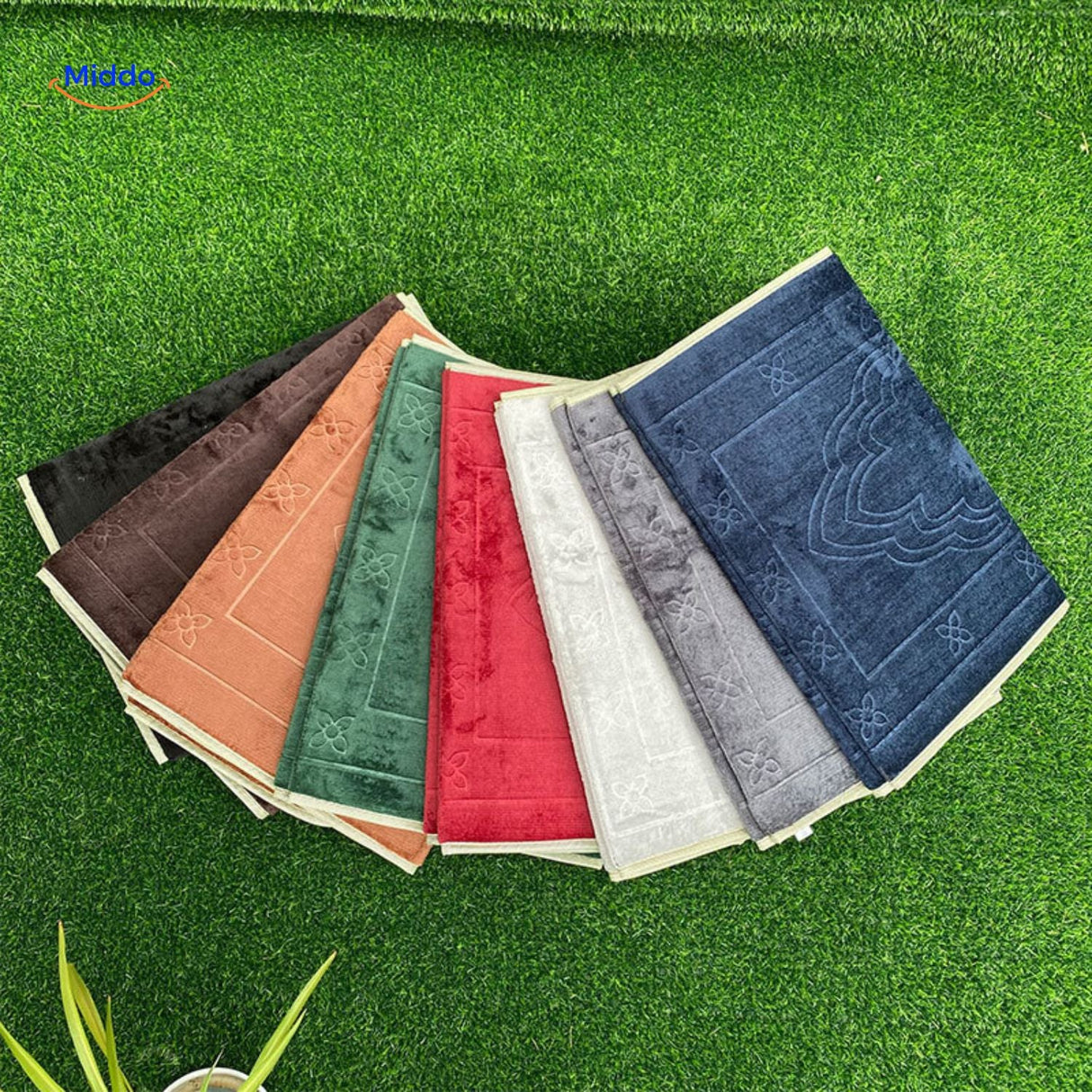 Portable padded prayer mat collection shown folded and stacked in all available colors.