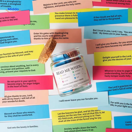 Prayer jar with colorful bible verses and wooden label on glass pot.