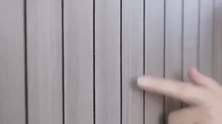 Grey wood-grain 3D wall panel displaying smooth flat-surface texture variation.