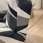 Reclinex recliner cover fitted on chair in black white gray pattern.
