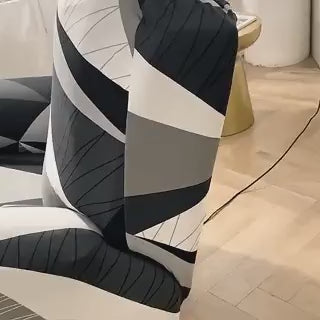 Reclinex recliner cover fitted on chair in black white gray pattern.