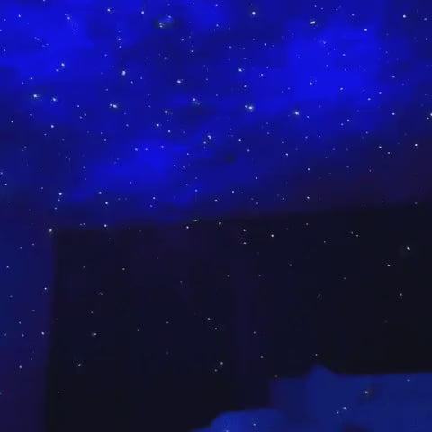 Astronaut galaxy projector creating starfield ceiling projection with constellation patterns.