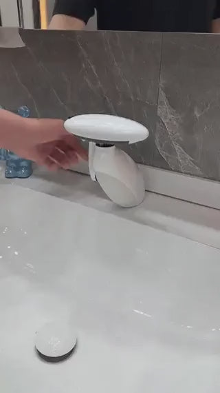 White pull-out LED bathroom faucet installed on a countertop vanity in a modern bathroom.