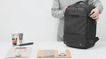 VacuPro compression backpack with multiple organizer pockets and accessories.