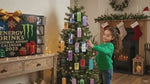 Child opening and discovering mini energy drink cans from the advent calendar.