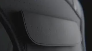 Close-up detail of waterproof premium fabric flap on reflective running vest for protection.